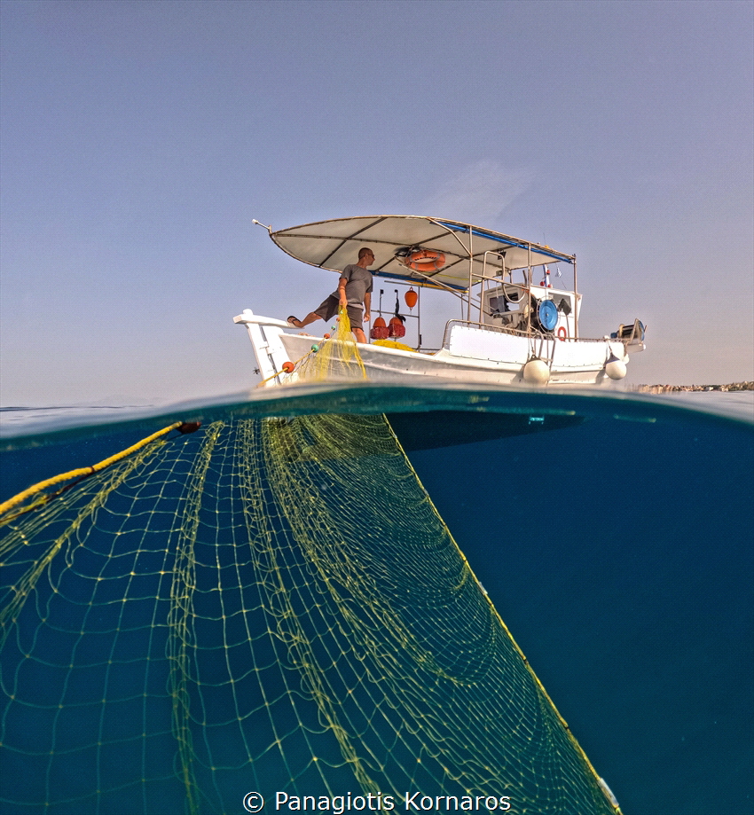 Hi ! Thats a friend fishing with his boat.I was freedivin... by Panagiotis Kornaros 