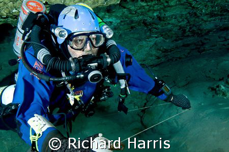 Making the jump. Cave diver running a jump reel. by Richard Harris 