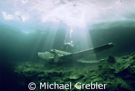 Diver with airplane under the ice at Morrison's Quarry. N... by Michael Grebler 
