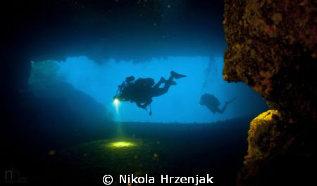 Divers in cave exploration by Nikola Hrzenjak 