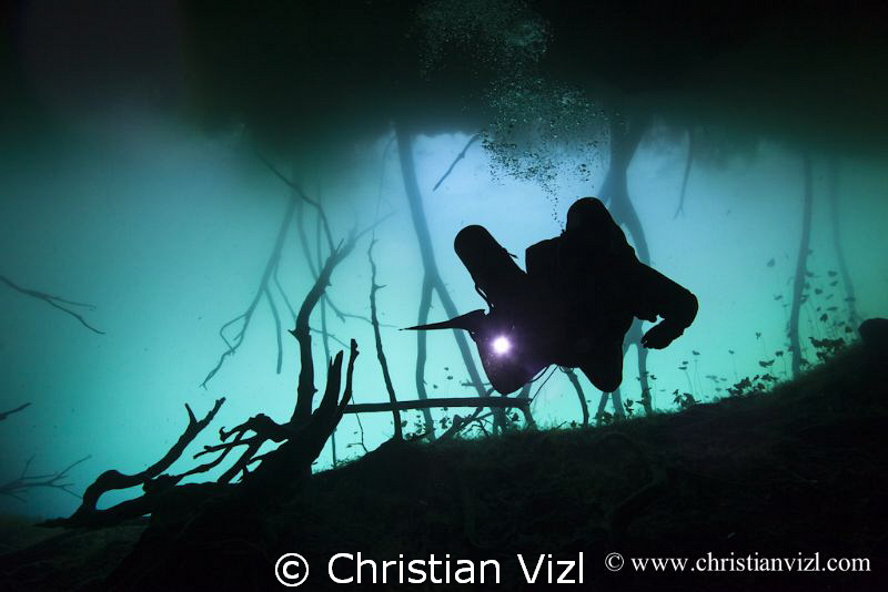 Cave diver at cenote Aktun Ha, Quintana Roo, Mexico by Christian Vizl 