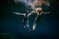 Cenote Trash the dress. Flying bride and groom in mexican cenote.