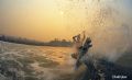 This image was shot during the San Diego fires in 2003. Due to the extreme coverage of smoke and ash in the air the sky stayed a warm color for about 4 days. This was taken around 10am at Seaside Reef in Cardiff. The surfer is Gavin Sutherland.