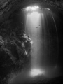 This image was taken at 'The Pit Cenote' in Tulum, Mexico. Freedivers were practicing as I took the image. One waiting on a rock while the other diver ascends. The hydrogen sulfate layer can be seen below at 90ft.