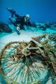 Diving at a popular site in Cozumel, my buddy and I found this strange wreck on the sandy bottom that turn into a small coral reef. The current was strong so compose properly the image was quite a challenge.