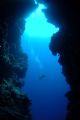 Diver swims past cave entrance, Bunaken National Park.
10.5mm Fisheye Lens.