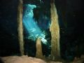 Stalactites and stalagmites in the Dos Ojos cave system in Yucatan, Mexico. Behind you see the sunlight coming through a sinkhole. Taken with strobe and wide angle.