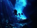 Divers exploring the cave system of Chac Mool. Fresh water. No strobe. Dome port used.