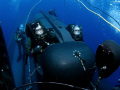 SEALs going to work/ SEAL Delivery Vehicle team launching from the back of a submerged submarine. (photo Released)