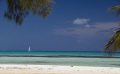 A sailboat passes by Cayman Kai, on the North shore of Grand Cayman.  The really small white dots on the horizon line are dive boats on the North wall.  A beautiful place to dive.  A beautiful place to 