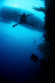 Freefallin the wall.  Dive Master Paul in Tubbataha. Azores Live-a-board in the background.