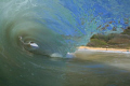 7am at Sandy Beach on the East side of Oahu, Hawaii. Canon camera, 18mm lens, Liquideye waterhousing. The girl on the beach was the only person in the water and she was catching some wild rides. In the image you can see her watching me get barreled!