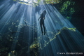 Morning sun rays at Cenote Cristalino, Quintana Roo, México. The model was freediving and amazed by the awe of the beauty in this spectacular natural wonders.