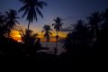 Indonesian fishing village at sunset with volcano in the background. Paradise