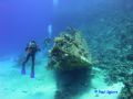 Photographer and wreck of a yacht, Red Sea